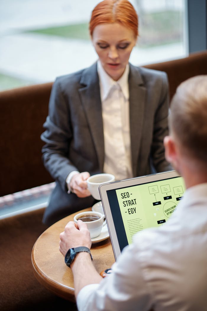 hero-img Professional meeting in a café with a laptop showcasing an SEO strategy. Ideal for business concepts.